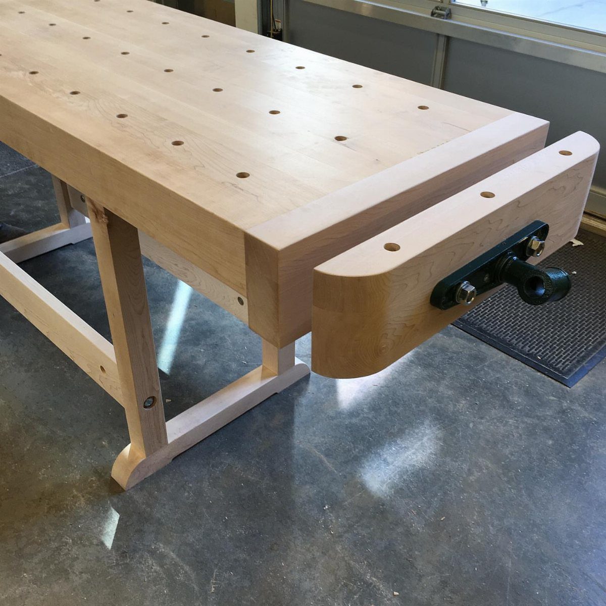 5 Woodworking End Vise Ideas for Your Workbench 3 Wooden workbench with a built-in end vise and dog holes on the tabletop
